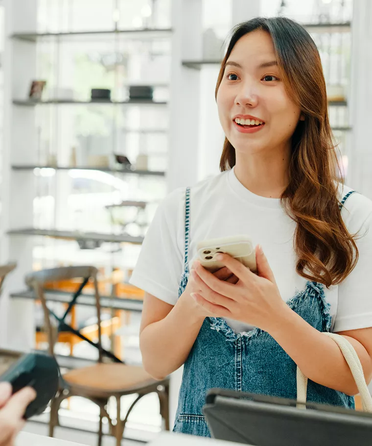 Woman making purchase with phone