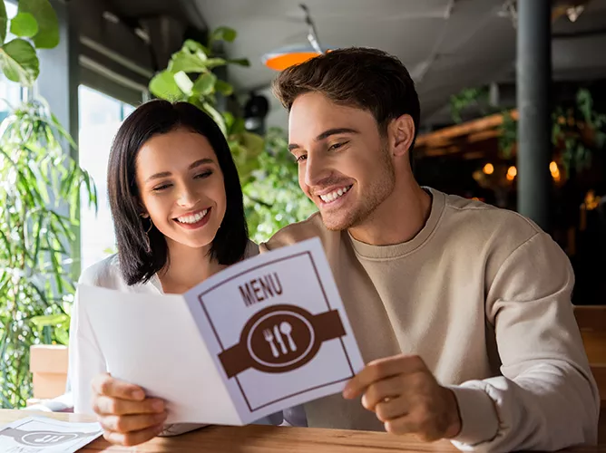 restaurant workers looking at menu teaser