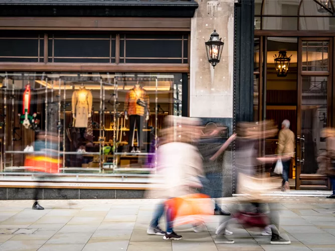 people walking infront of store