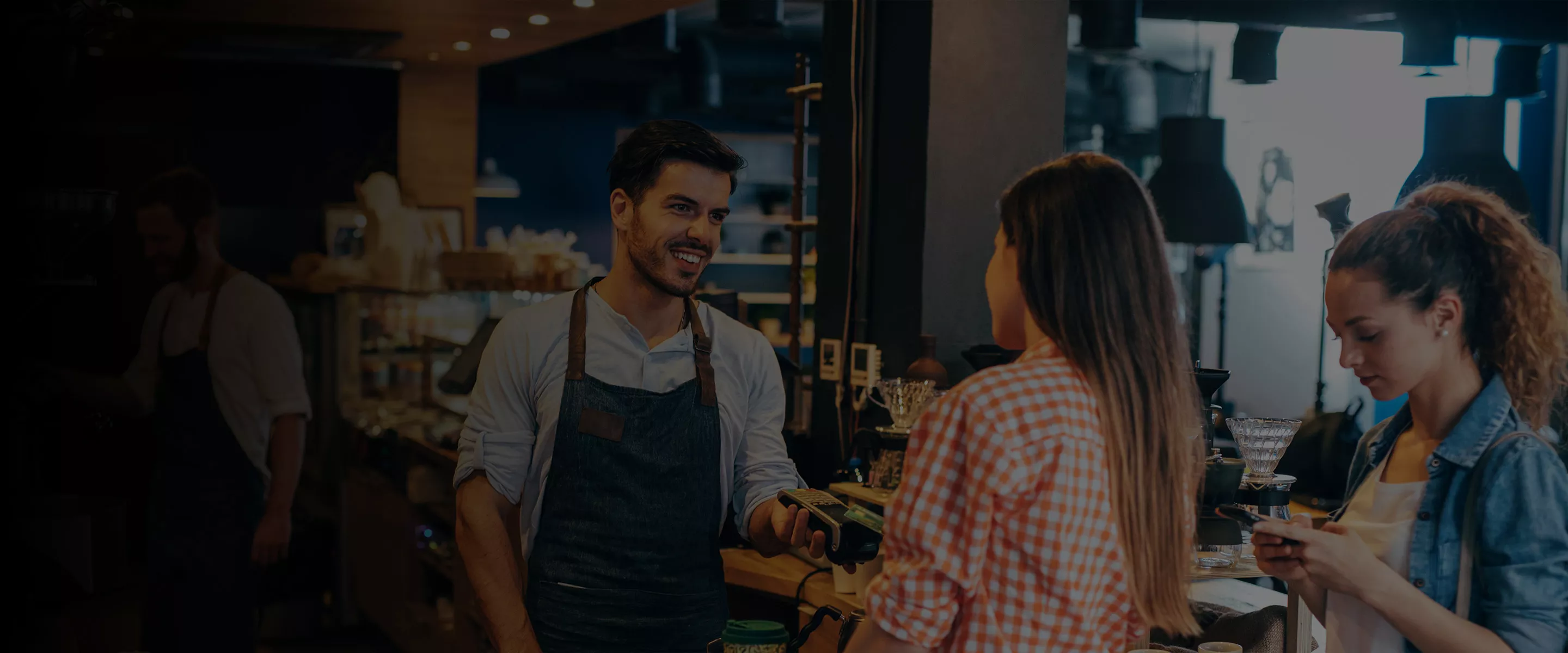 Two women buying coffee