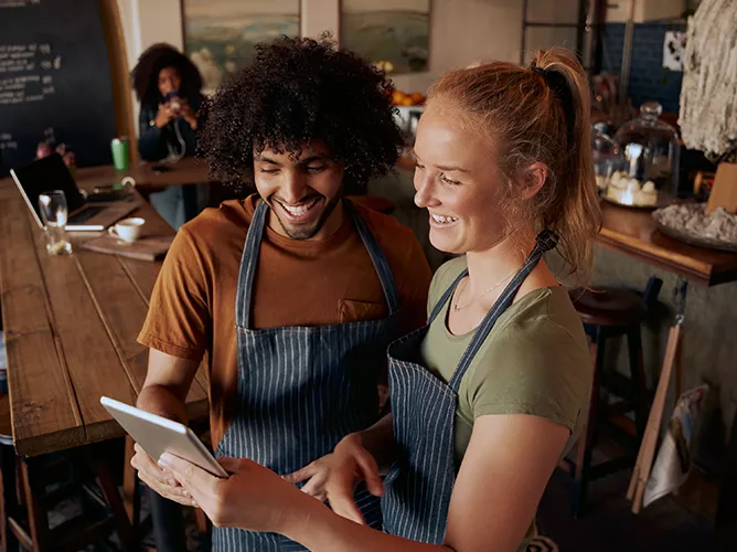 Two workers using restaurant technology teaser