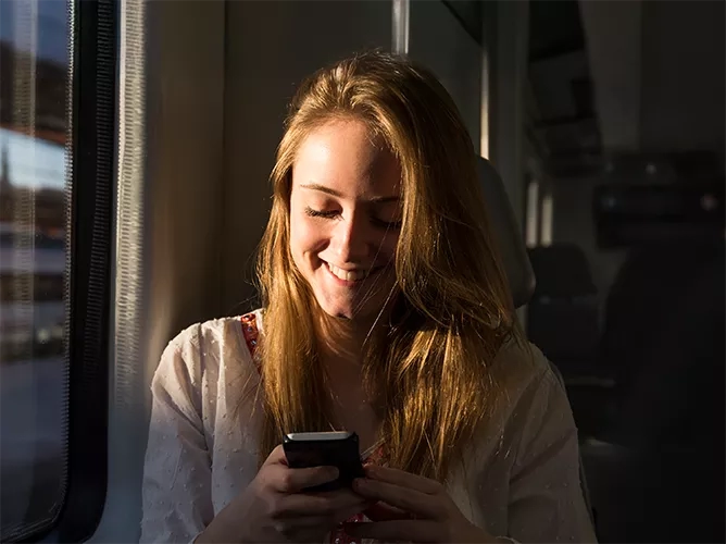 Girl looking at phone smiling