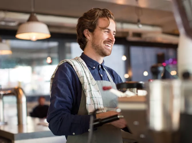 Man serving coffee in a diner